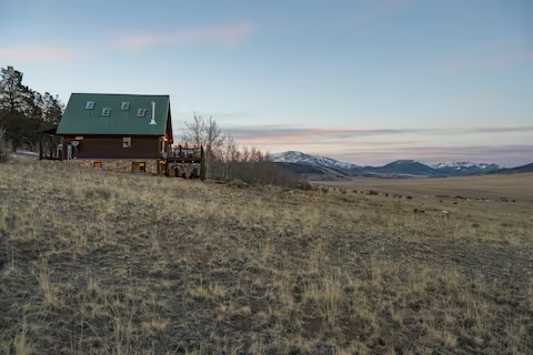 Mountain views from Skyfall Chalet in summer with green meadows and blue skies