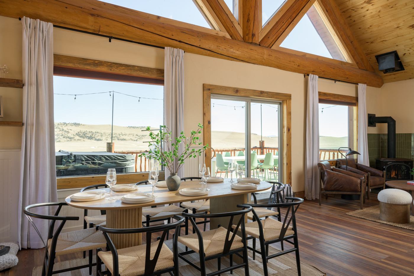 Dining area with vaulted prow windows and hot tub view