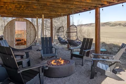 Fire pit lounge area with Adirondack chairs and mountain views