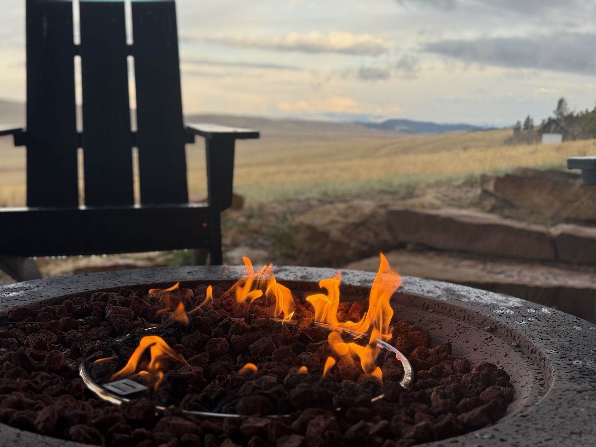 Fire pit at sunset with mountain views at Skyfall Chalet
