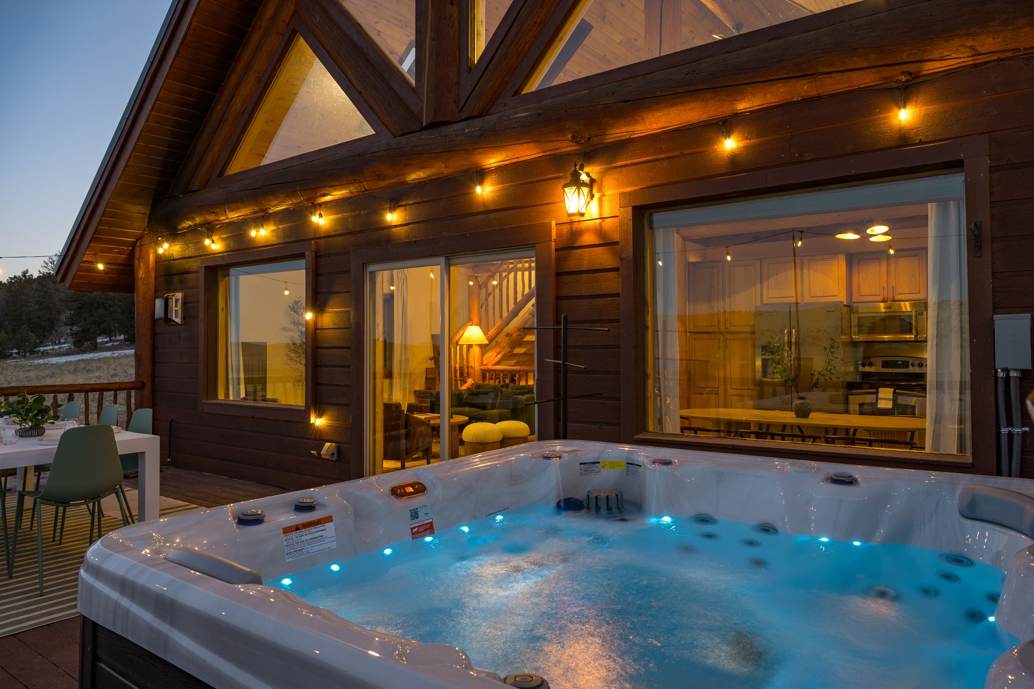 Hot tub at night under dark starry skies at Skyfall Chalet