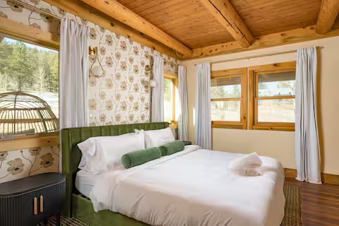 Master bedroom with cozy green headboard